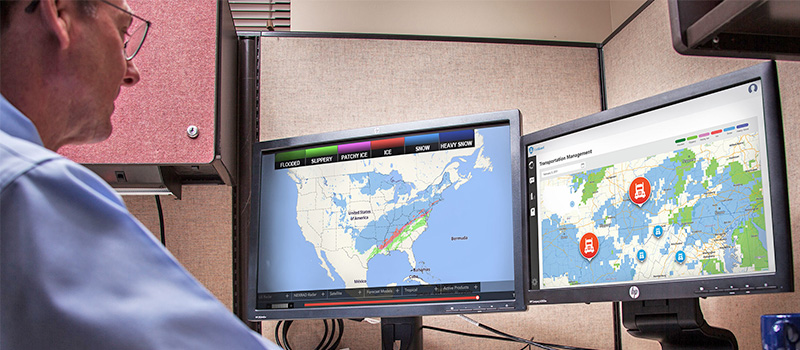 Dispatcher monitoring weather for fleet